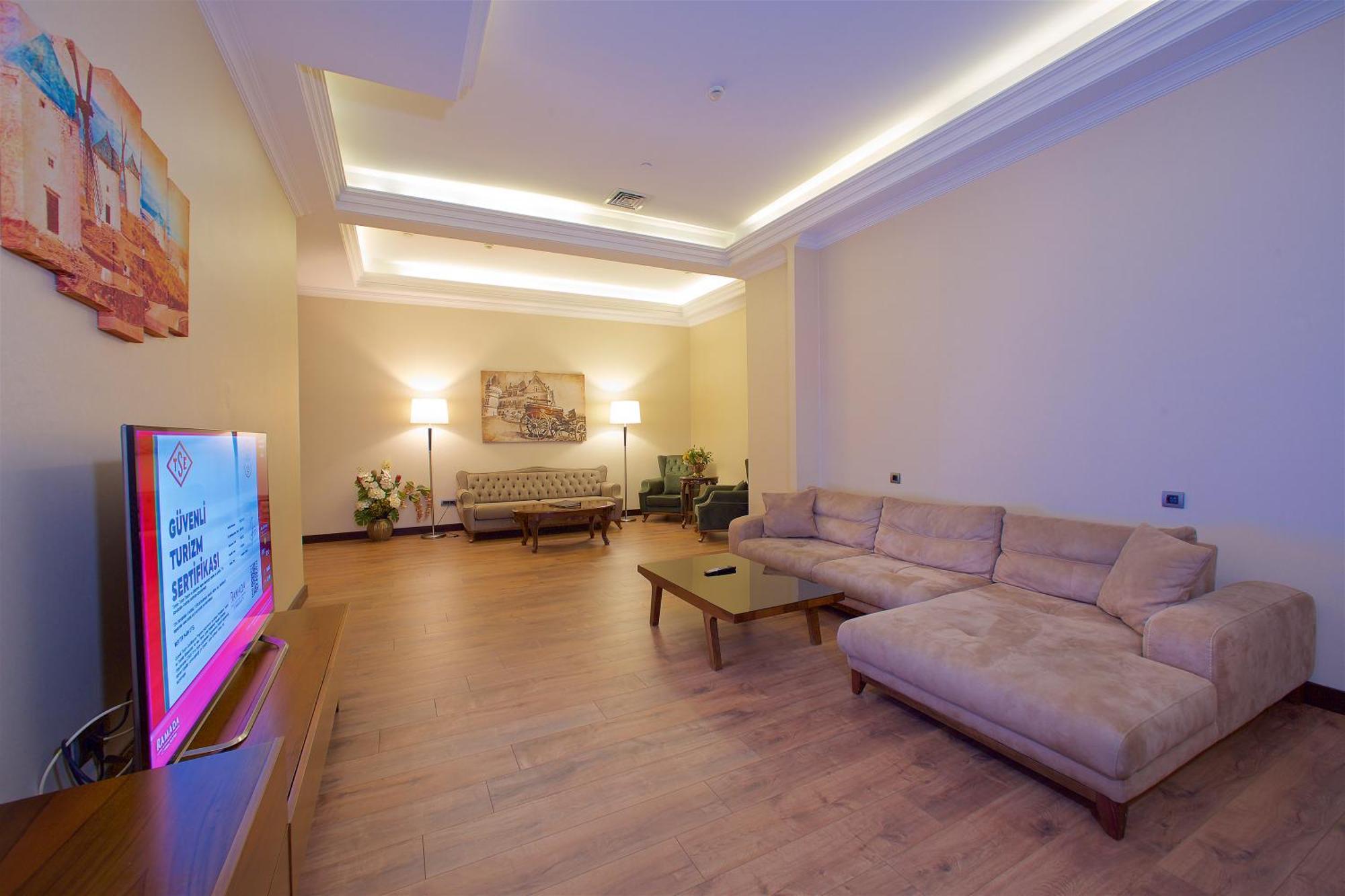 Ramada By Wyndham Istanbul Merter Exterior photo A living room in a suite at the hotel