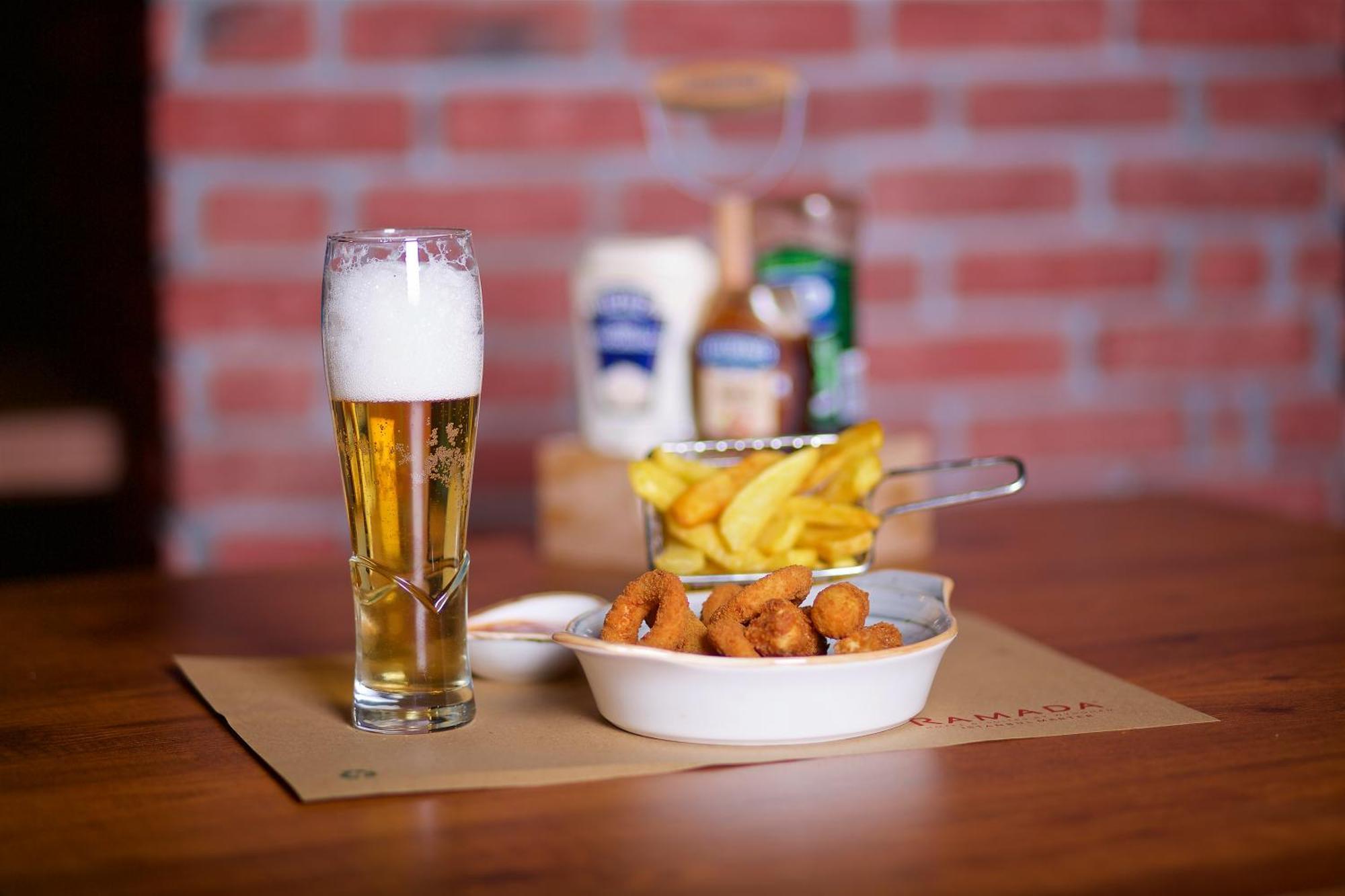 Ramada By Wyndham Istanbul Merter Exterior photo A glass of beer with patatas fritas and croquetas